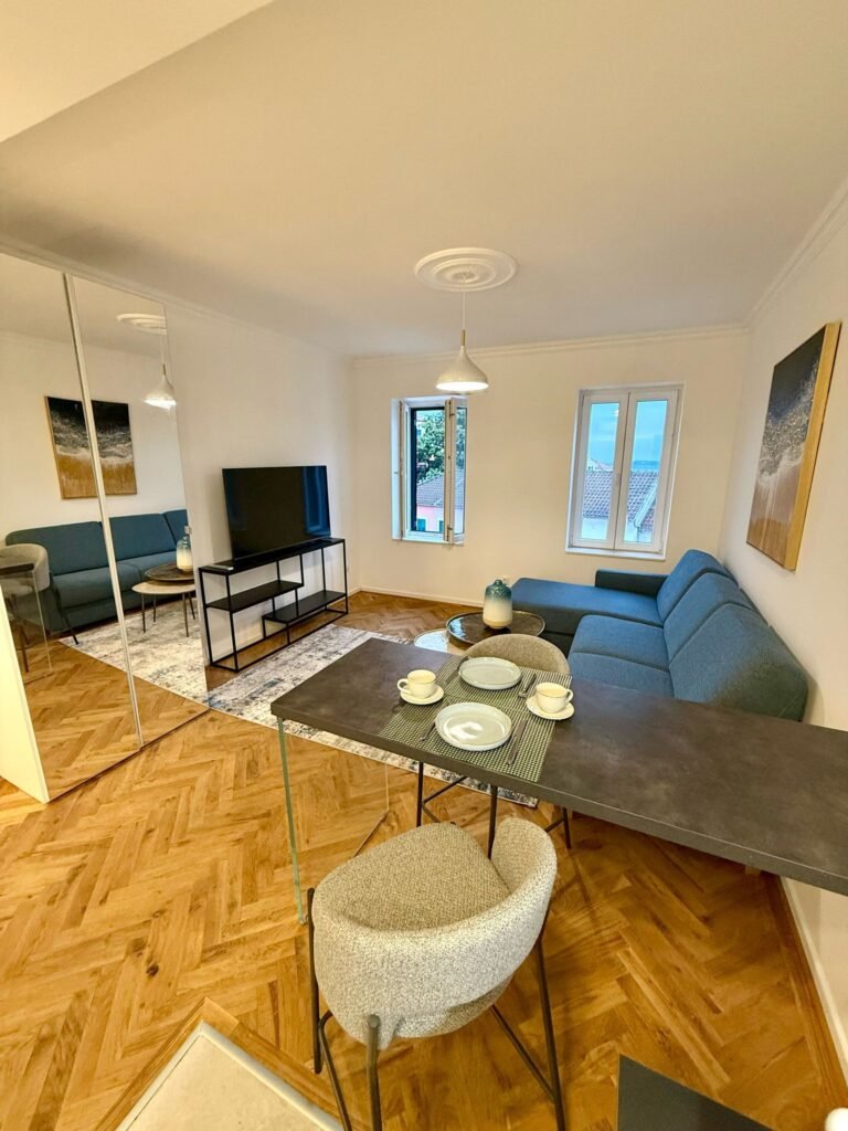 Modern apartment living room with dining area.| Rochefort's INTERNATIONAL REALTY